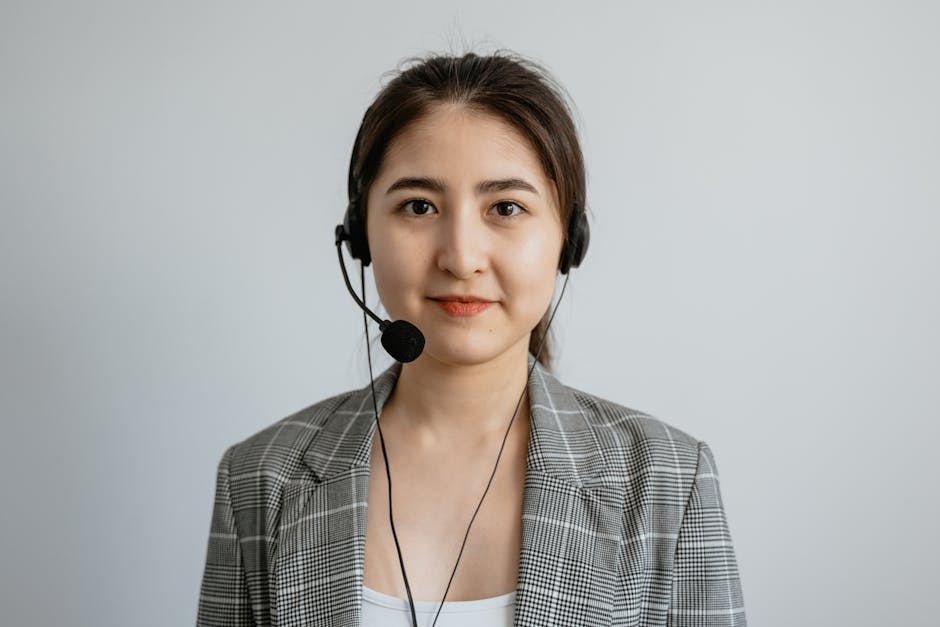 Portrait of a young female call center agent in a professional setting wearing a headset.